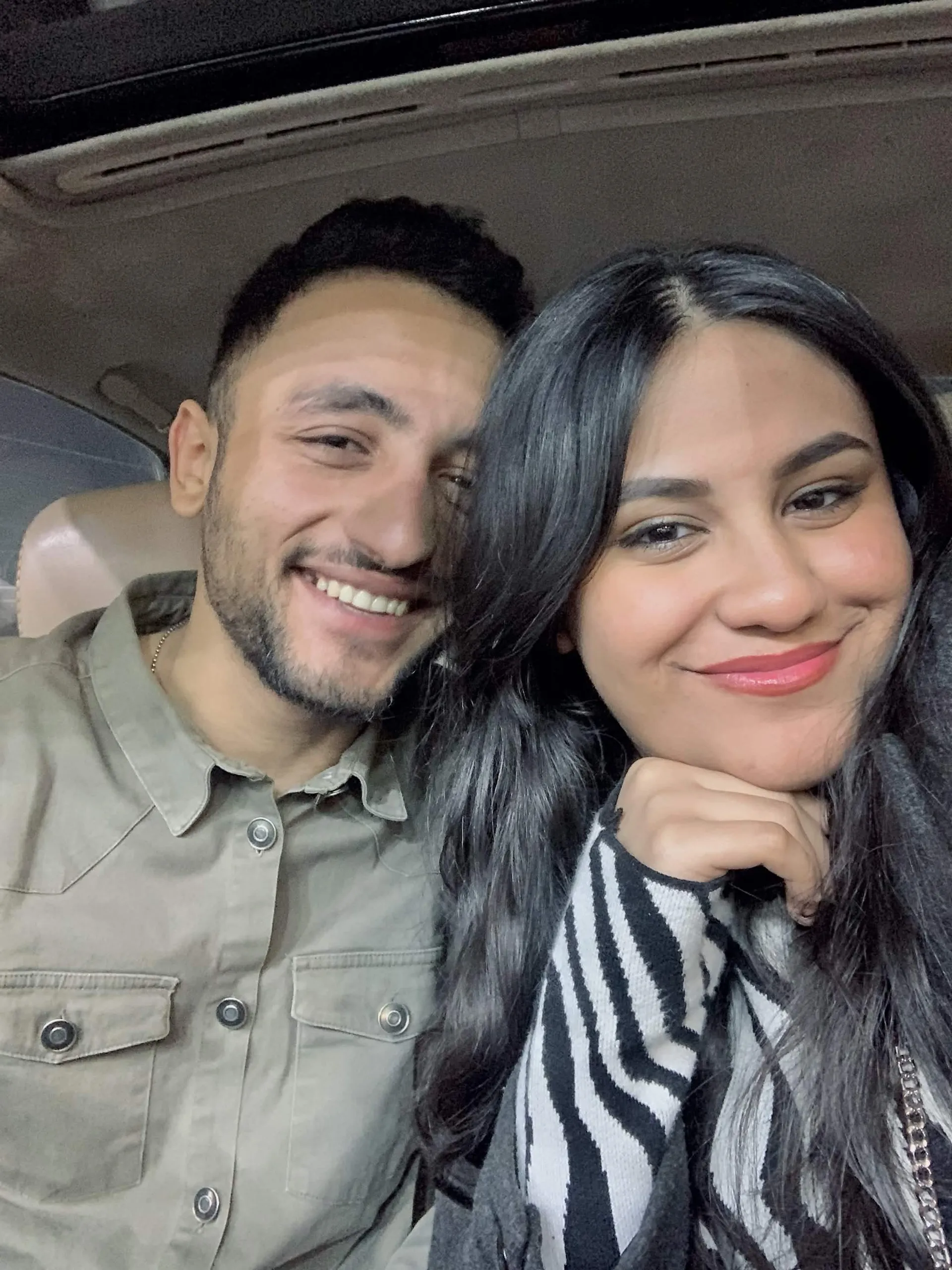 Muhammed and Merna smiling together in the car