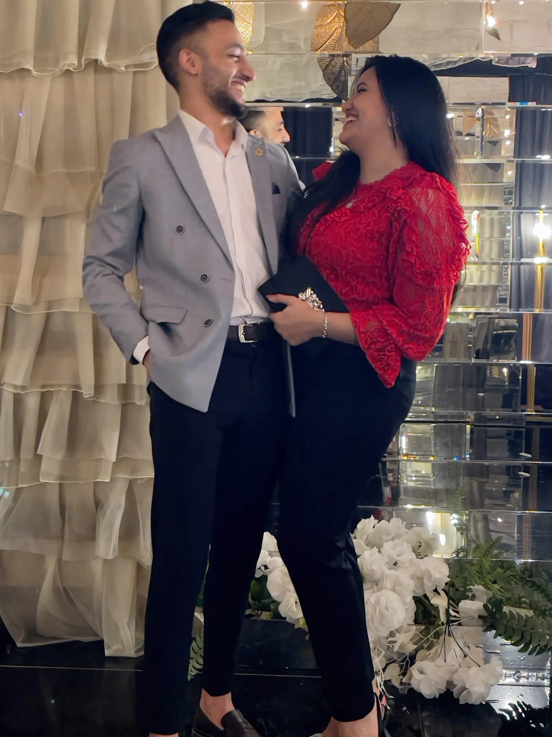 Muhammed and Merna laughing together at a celebration